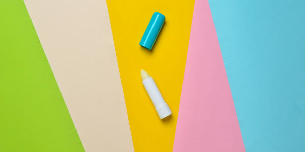 hygienic lipstick on a colored paper background, minimalism, top view
