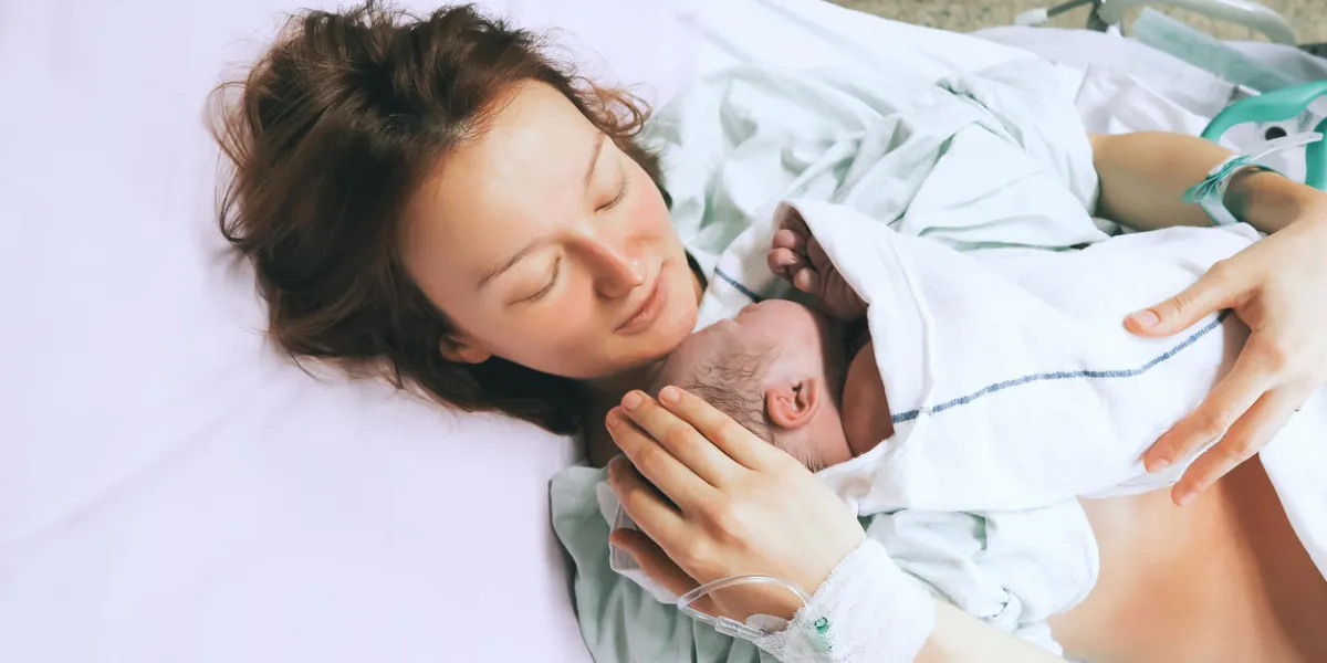 mother holding her newborn baby child after labor in a hospital mother giving birth to a baby boy parent and infant first moments of bonding mother holding her newborn baby child after labor in a hospital mother giving birth to a baby boy parent and infant first moments of bonding