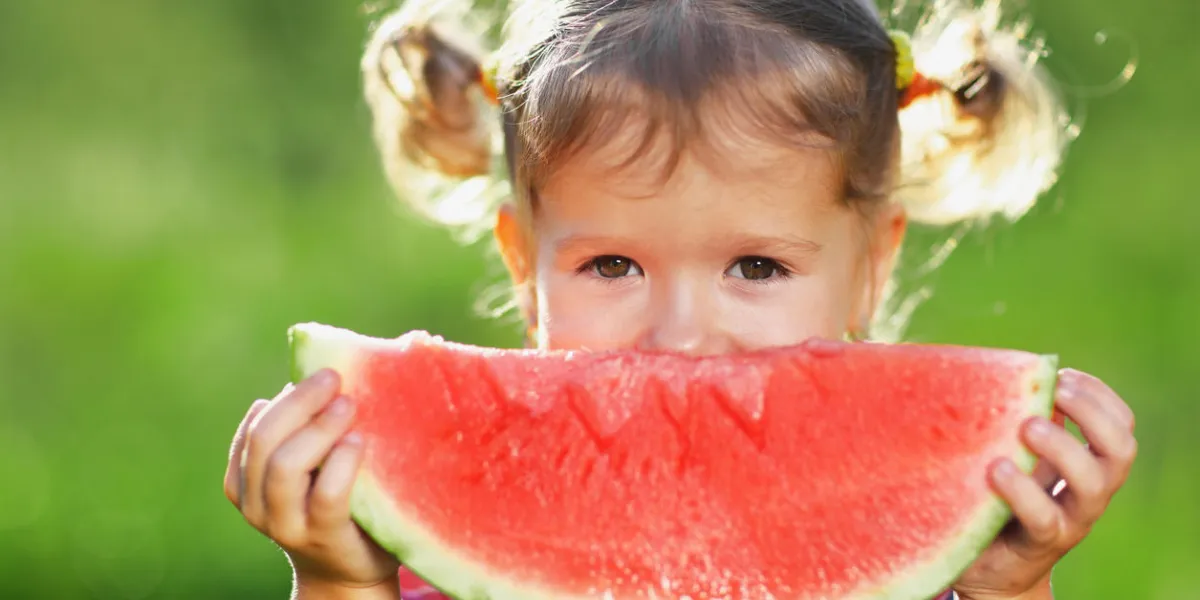 happy child girl eats watermelon in the summer happy child girl eats watermelon in the summer