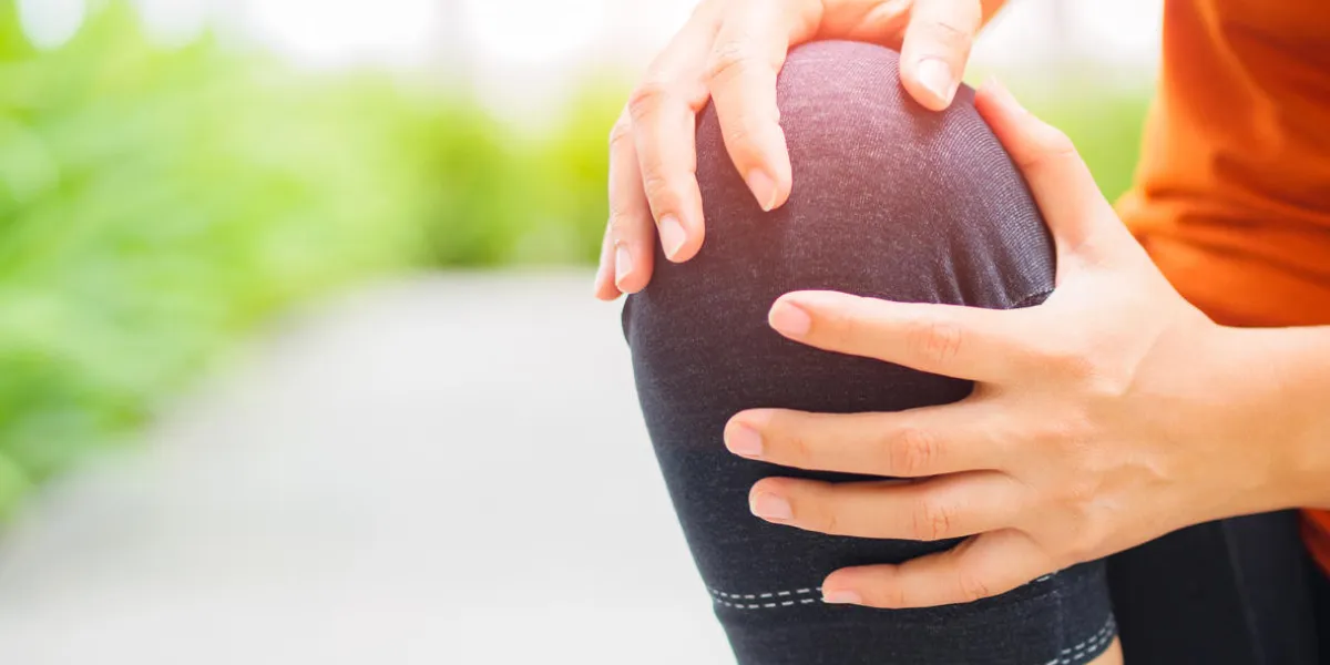 runner sport knee injury woman in pain while running in the garden runner sport knee injury woman in pain while running in the garden