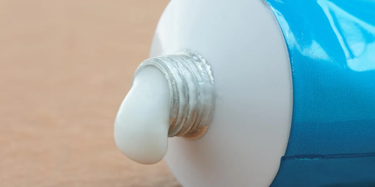 a tube of generic ointment or cream with a droplet squeezed out