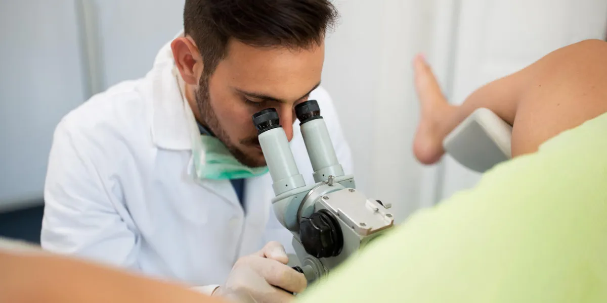 young professional gynecologist exam patient with colposcope, healthcare concept