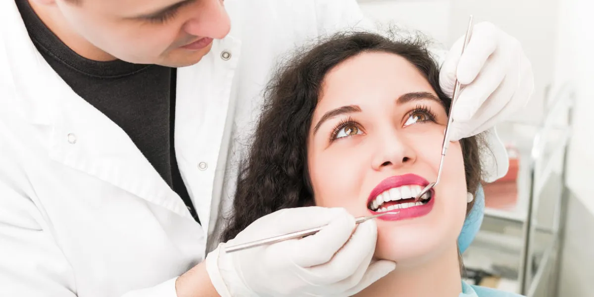young woman having teeth examined at dental office