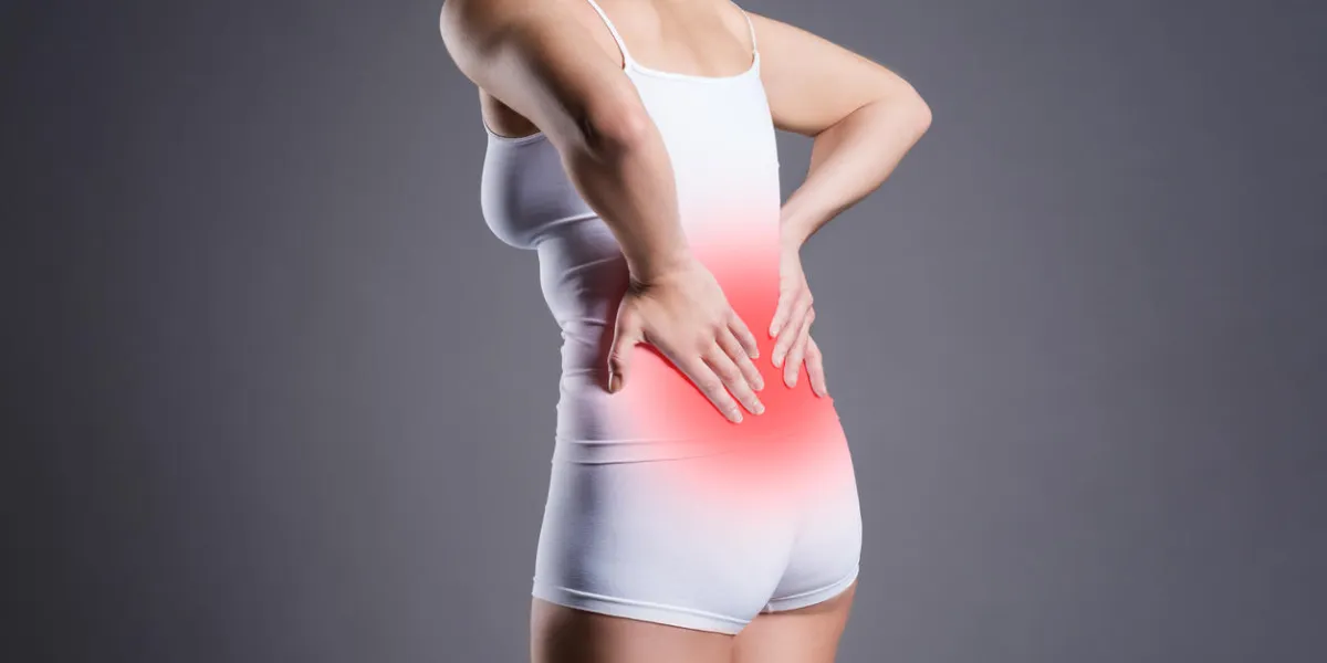 back pain, kidney inflammation, ache in woman's body on gray background