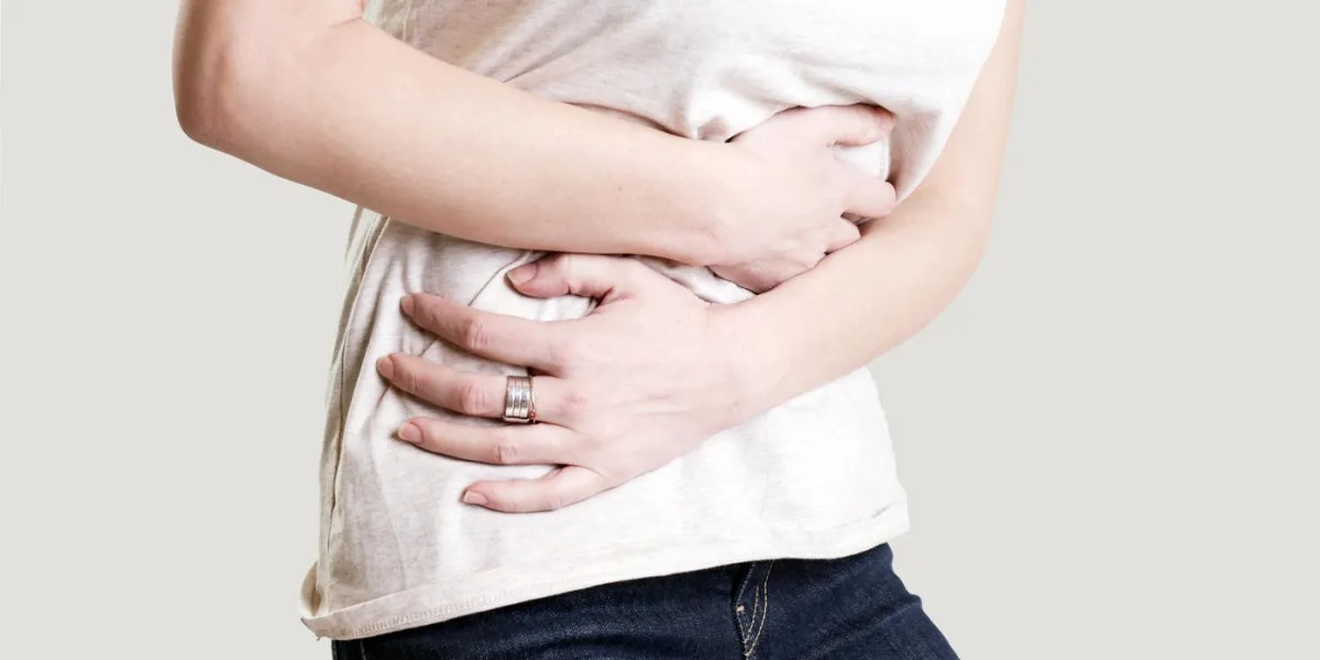 woman having painful stomachache, chronic gastritis or abdomen bloating