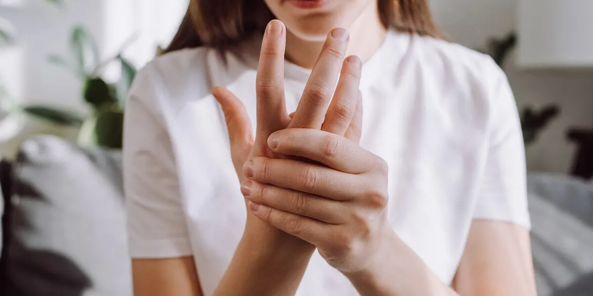 sad girl massage hand with wrist pain, rheumatoid arthritis concept close up of young woman suffer from numbing pain in hand, numbness fingertip, arthritis inflammation, peripheral neuropathies sad girl massage hand with wrist pain, rheumatoid arthritis concept close up of young woman suffer from numbing pain in hand, numbness fingertip, arthritis inflammation, peripheral neuropathies