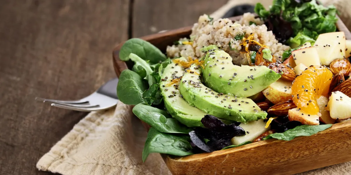 quinoa, avocado and apple salad perfect for the detox diet or just a healthy meal selective focus on front of dish with extreme shallow depth of field