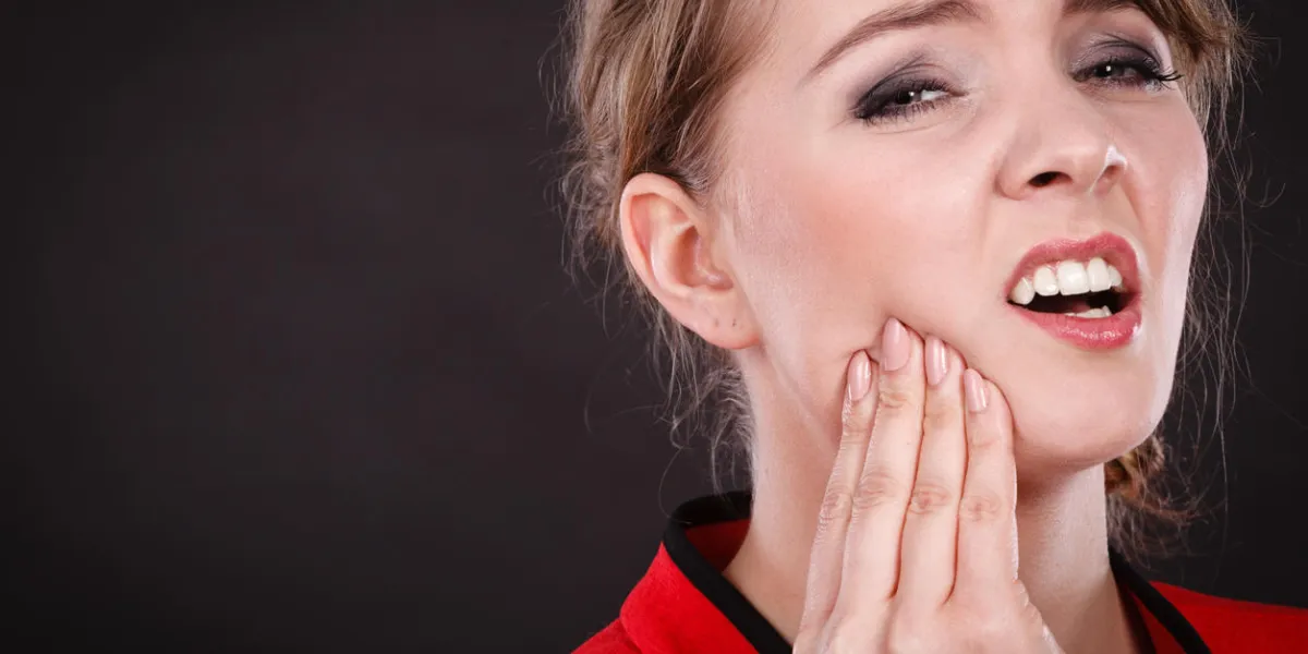 stress and pain face of young painful woman female feeling tooth pain ache girl touching her mouth teeth by hand