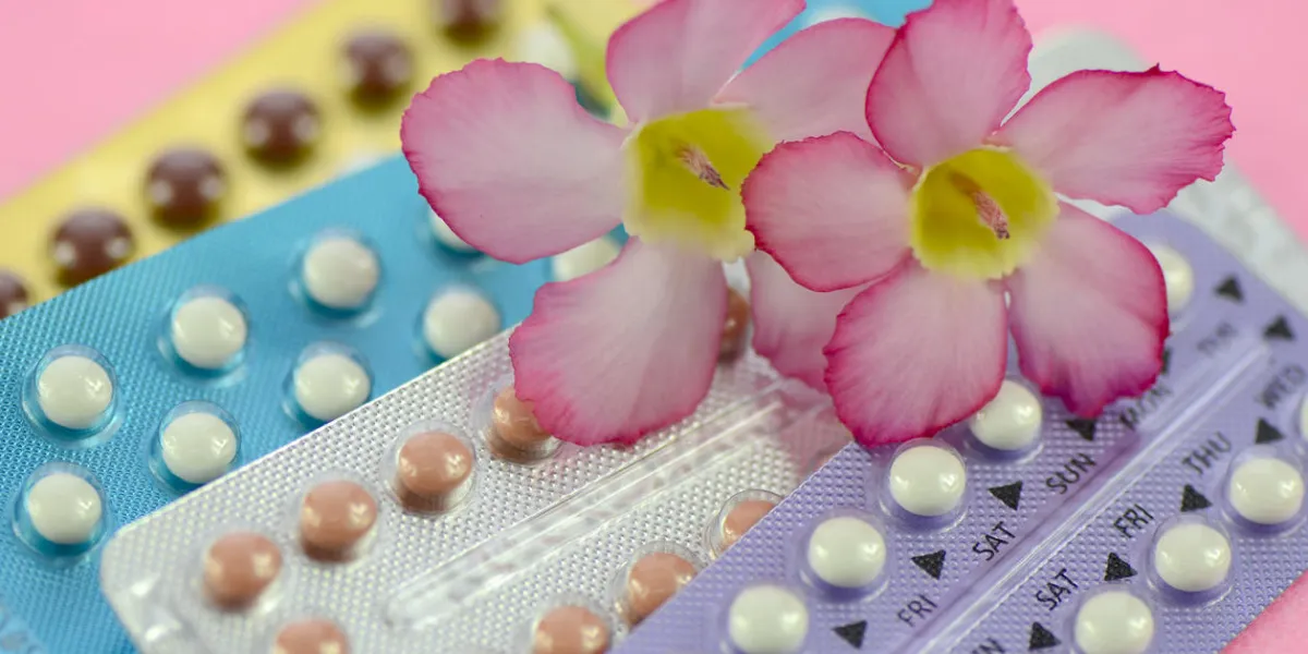 oral contraceptive on pink background in women health concept