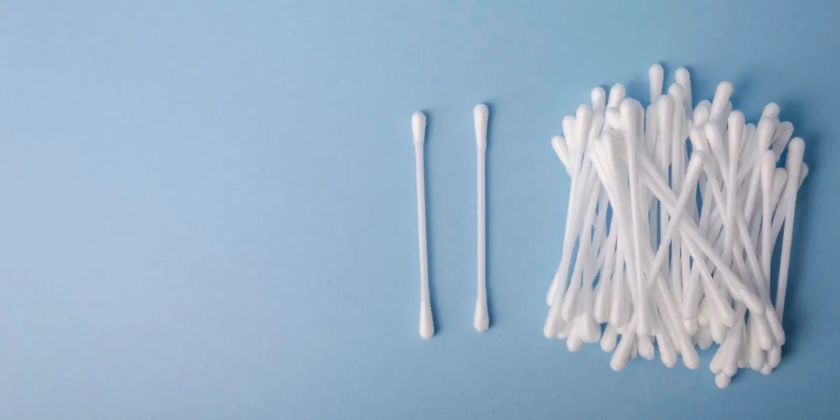 heap of cotton swabs on light blue background, hygienic cosmetic healthcare accessory heap of cotton swabs on light blue background, hygienic cosmetic healthcare accessory