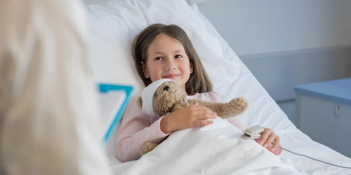 smiling little girl with oxygen saturated probe resting on hospital bed girl patient looking at doctor with a smile child and doctor at medical clinic smiling little girl with oxygen saturated probe resting on hospital bed girl patient looking at doctor with a smile child and doctor at medical clinic