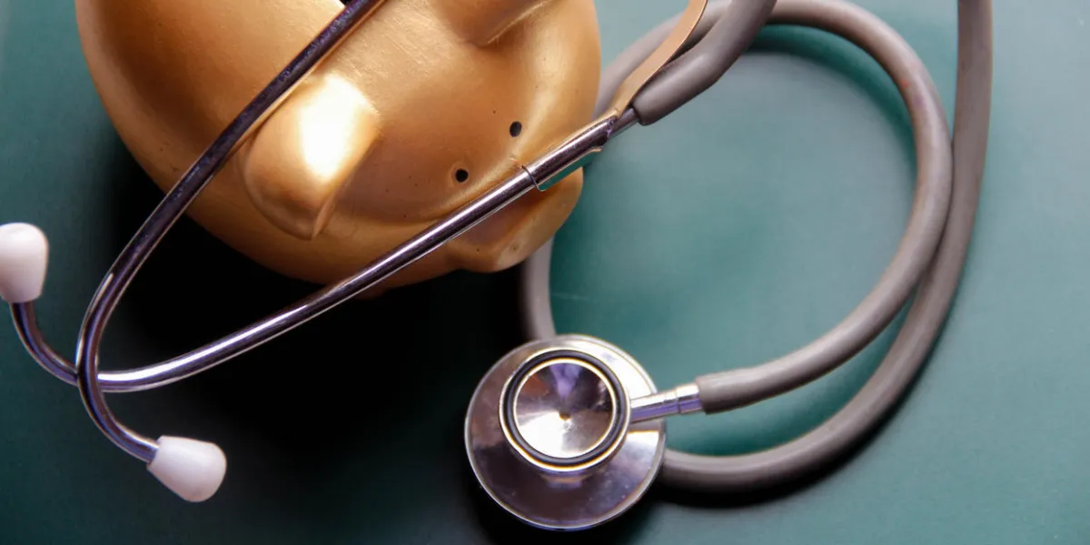 piggy bank with doctor’s stethoscope on green wooden board this photo may use as financial background piggy bank with doctor’s stethoscope on green wooden board this photo may use as financial background