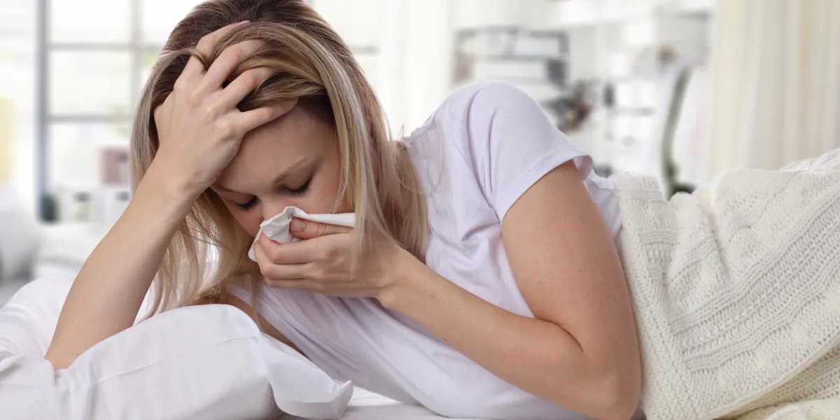 woman sneezing and holding tissue ,flu symptoms healthcare and medical concept