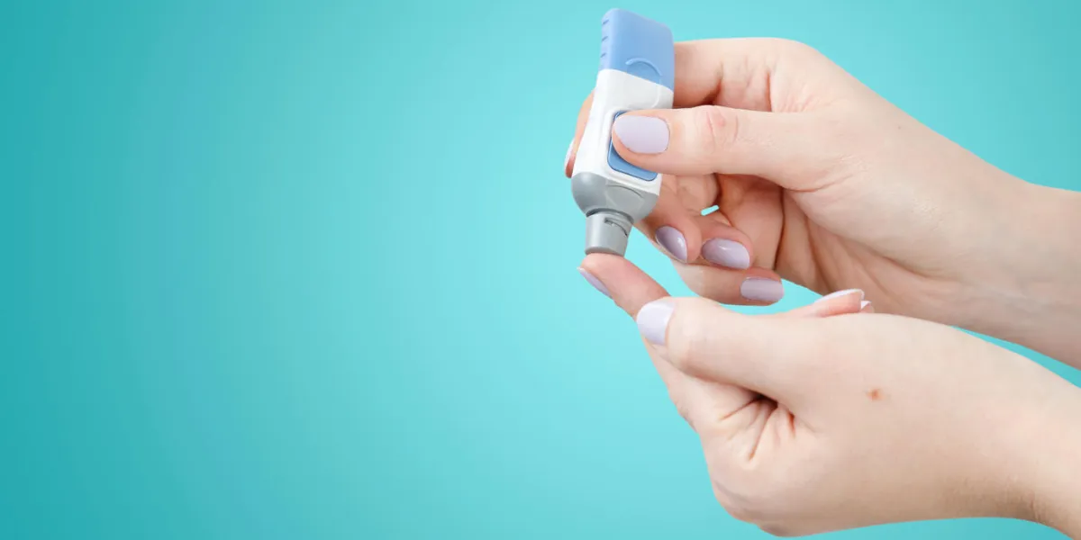 diabetes doing blood glucose measurement woman using lancet and glucometer