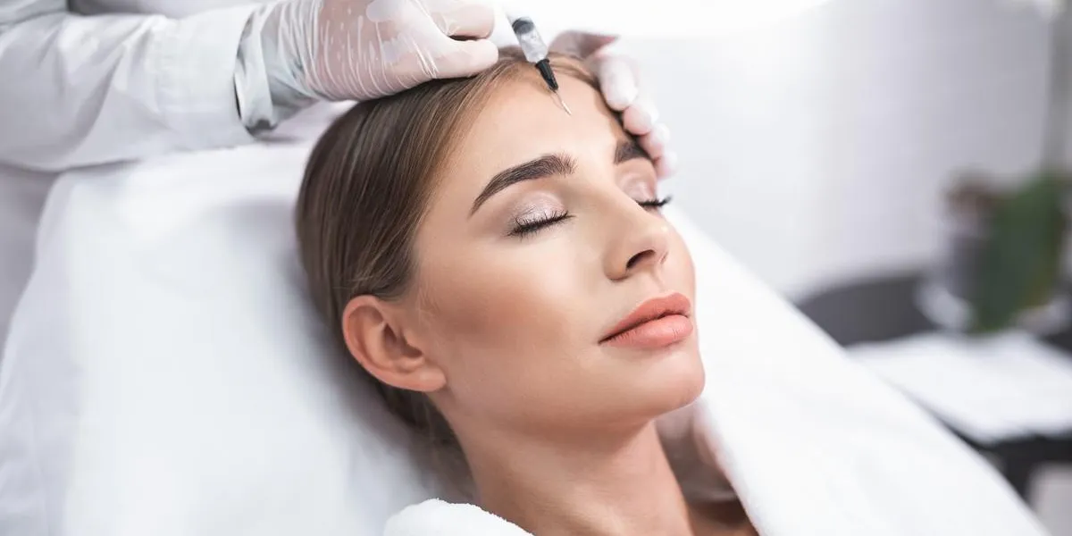 enjoying the procedure close up portrait of smiling young lady with closed eyes she is getting facial skin lifting treatment at beauty salon enjoying the procedure close up portrait of smiling young lady with closed eyes she is getting facial skin lifting treatment at beauty salon