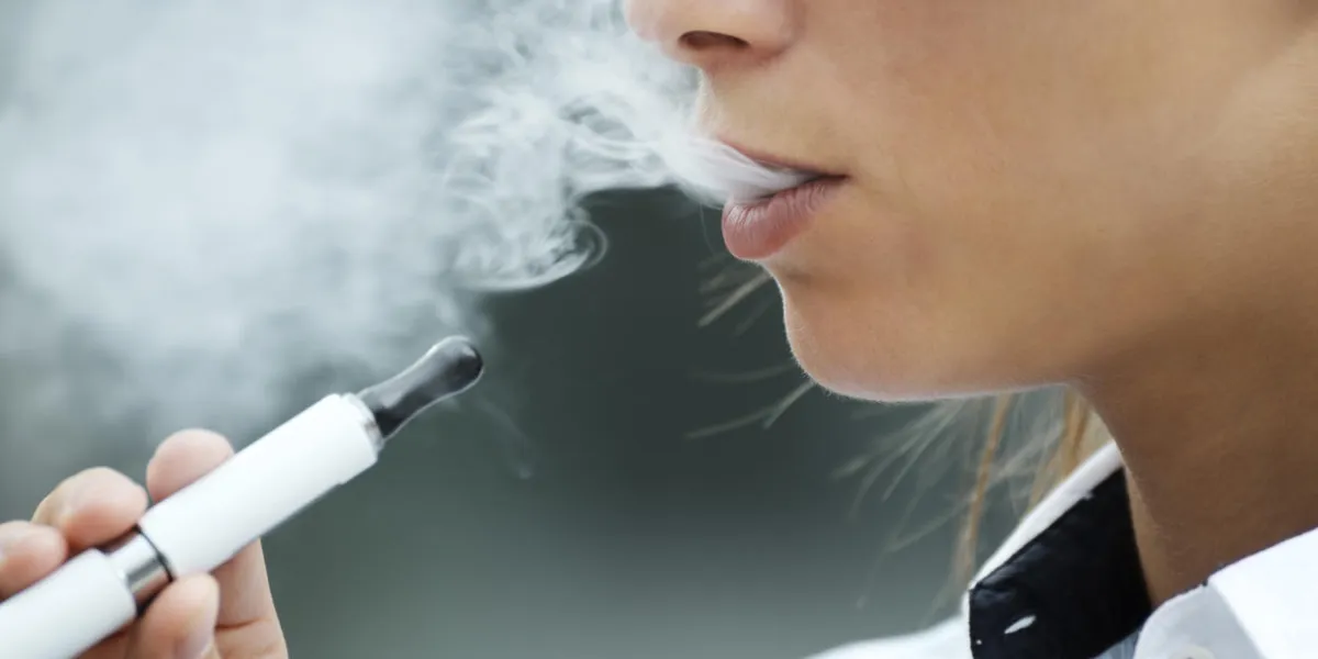 closeup of woman smoking e-cigarette and enjoying smoke copy space closeup of woman smoking e-cigarette and enjoying smoke copy space