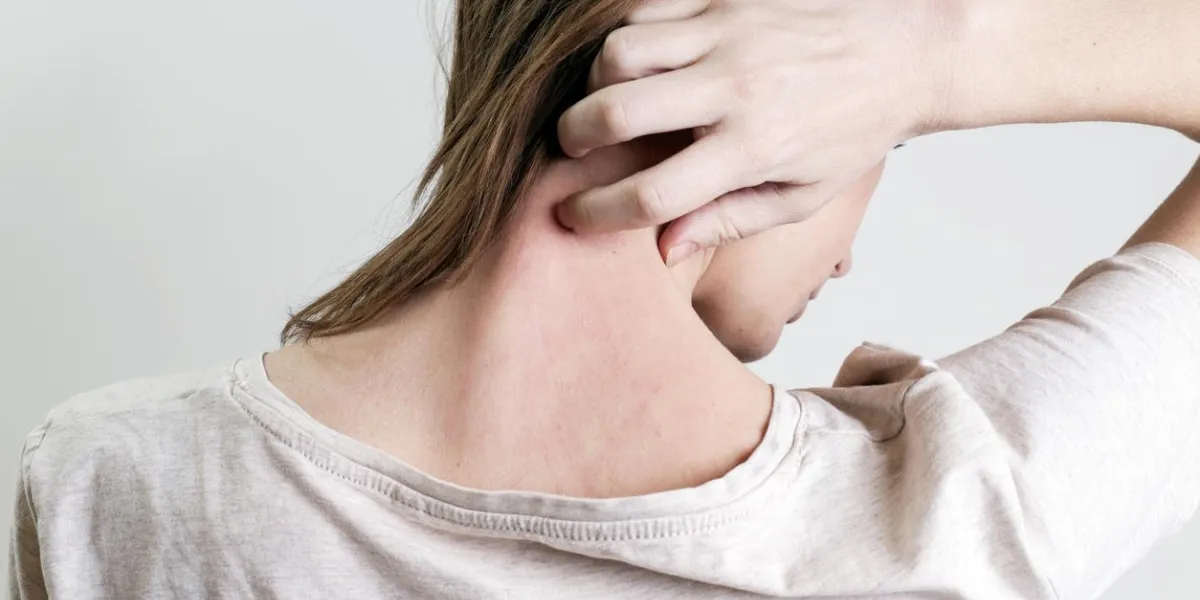 close up view of woman scratching her neck