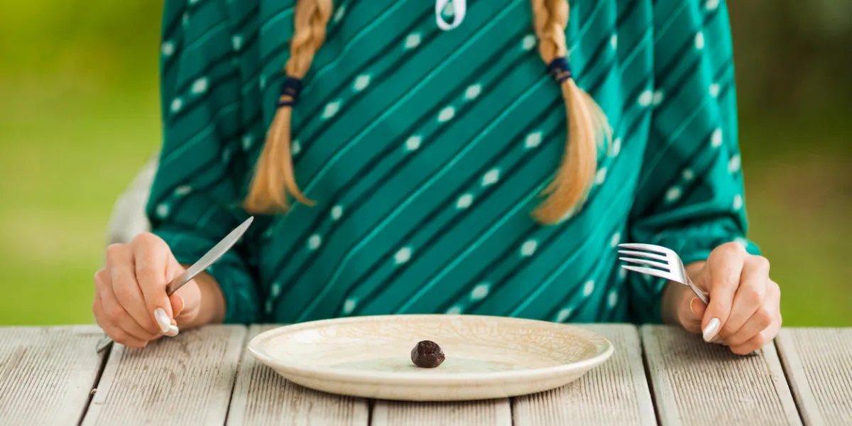 young woman is having meager meal in times of scarcity