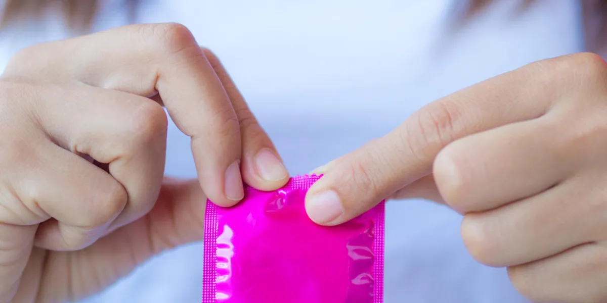hand holding condom, selective focus, save sex concept