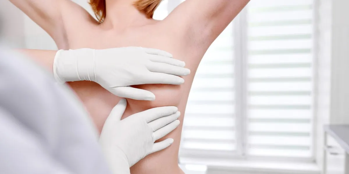 cropped shot of a woman standing topless getting her breast examined during medical appointment at the hospital copyspace cancer awareness prevention examination checkup medicine health