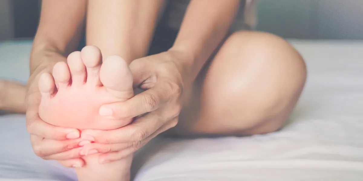 health care concept woman massaging her painful foot, red hi-lighted on pain area