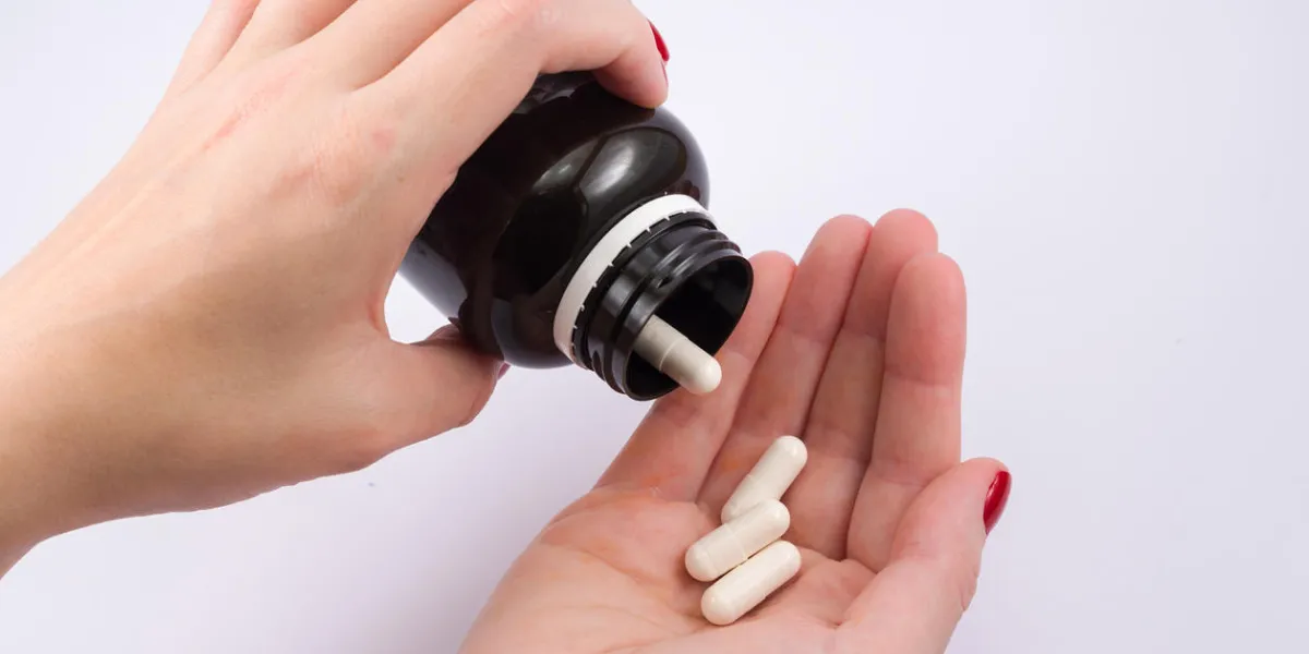woman hand turning medicine bottle in the palm of the hand doctor's prescription woman hand turning medicine bottle in the palm of the hand doctor's prescription