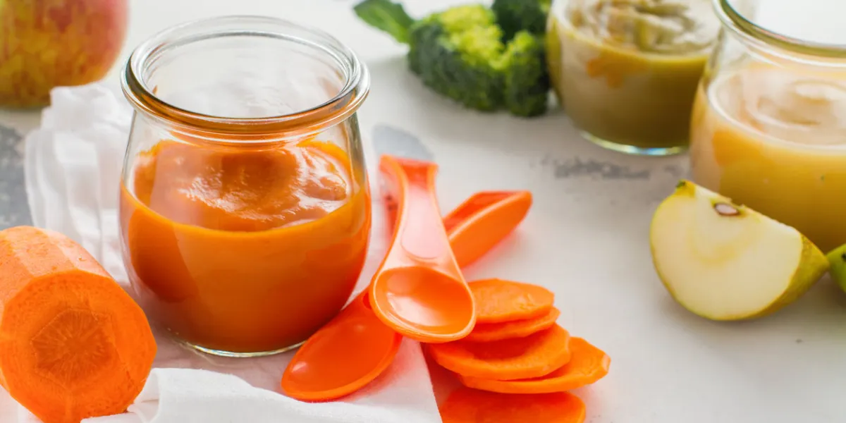 homemade carrot puree with ingredients on white background space for text