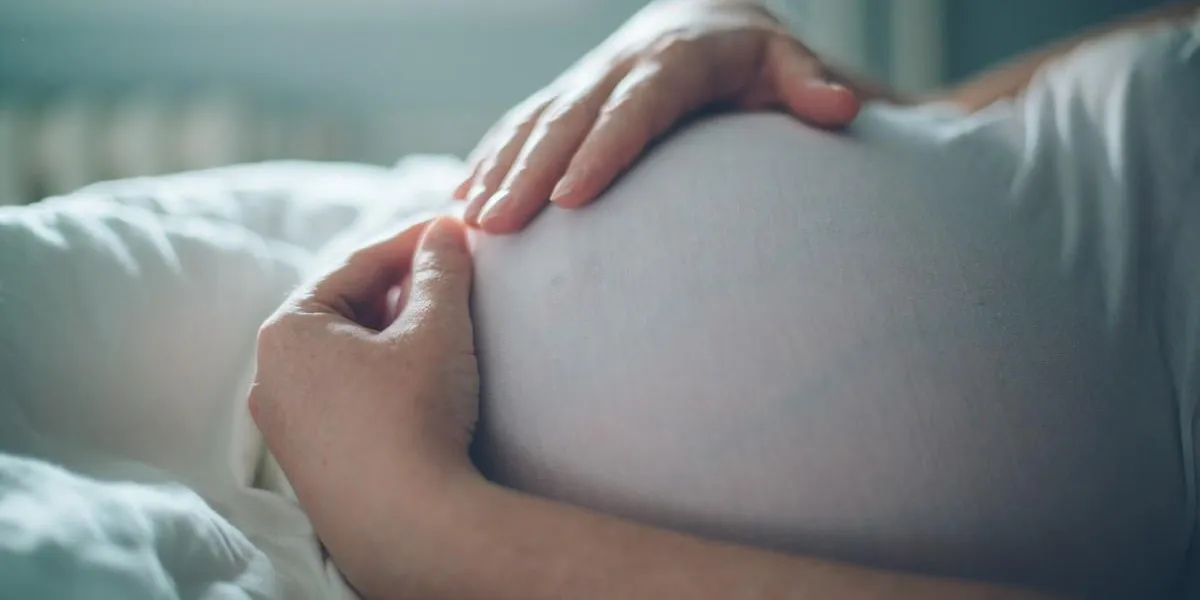 pregnant woman cuddling belly in bedroom at home just before the labor and childbirth, selective focus pregnant woman cuddling belly in bedroom at home just before the labor and childbirth, selective focus