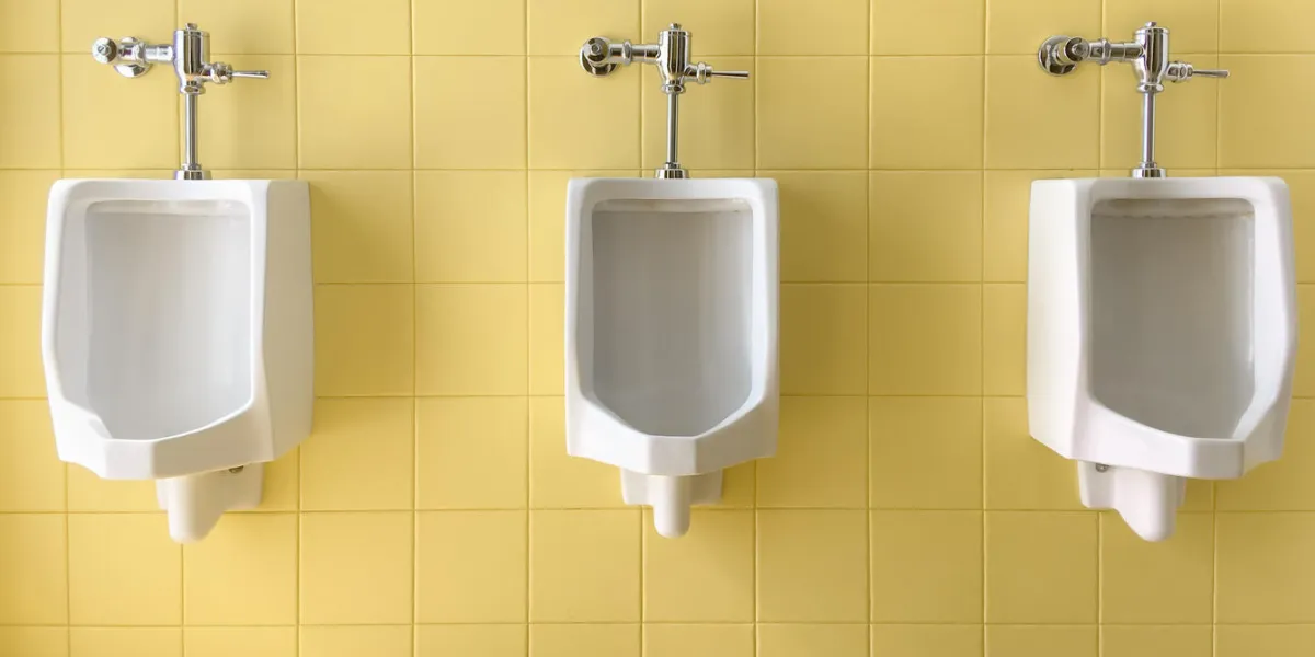 close up row of outdoor white urinals men on yellow of wall public toilet close up row of outdoor white urinals men on yellow of wall public toilet