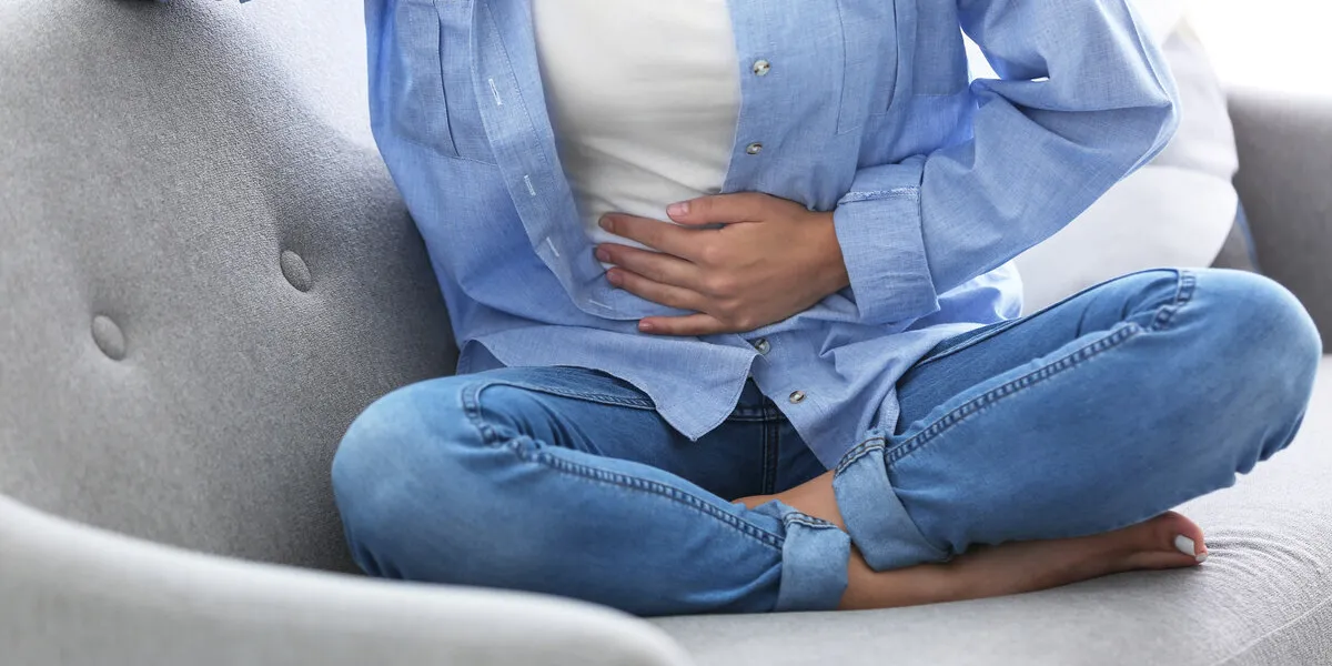 young woman suffering from menstrual cramps at home gynecology