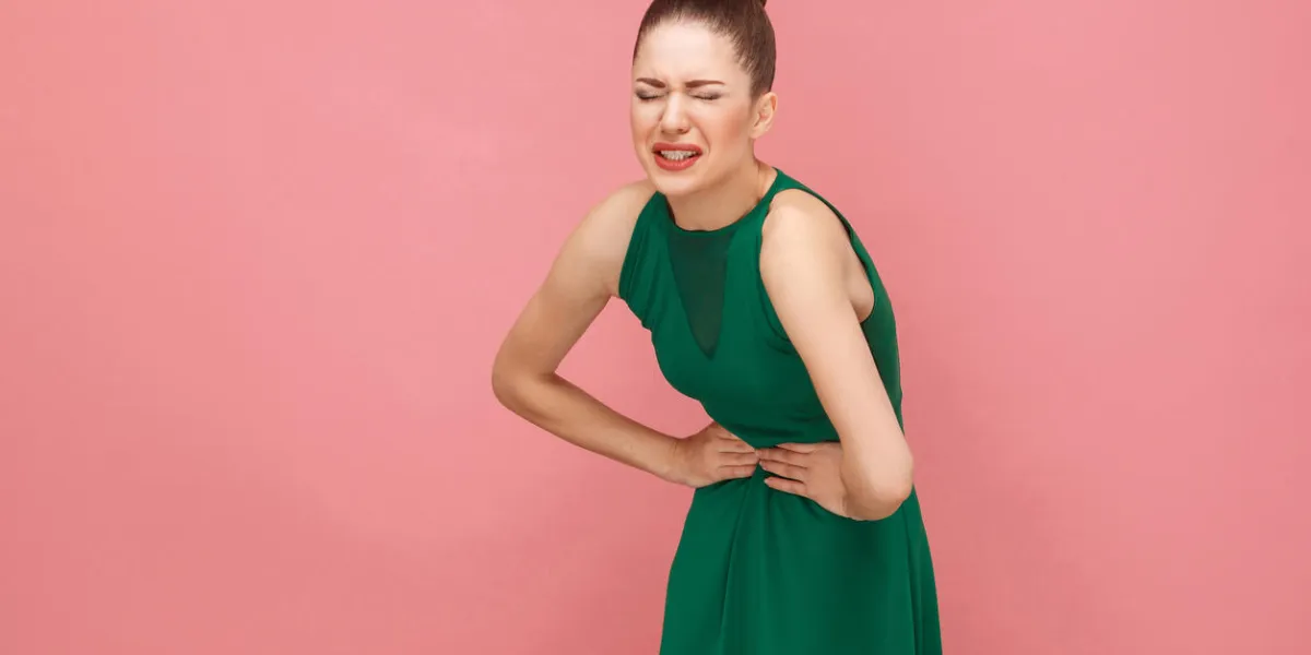 woamn have stomach pain pms or pregnant expression emotion and feelings concept studio shot, isolated on pink background woamn have stomach pain pms or pregnant expression emotion and feelings concept studio shot, isolated on pink background
