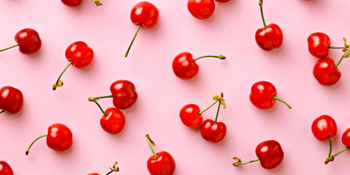 cherry pattern flat lay of cherries on a pink backgroundtop view