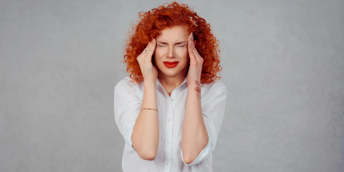 sadness and depression portrait stressed sad young redhead woman eyes closed, face down hands touching head isolated gray wall background negative human emotion, expression reaction, body language sadness and depression portrait stressed sad young redhead woman eyes closed, face down hands touching head isolated gray wall background negative human emotion, expression reaction, body language