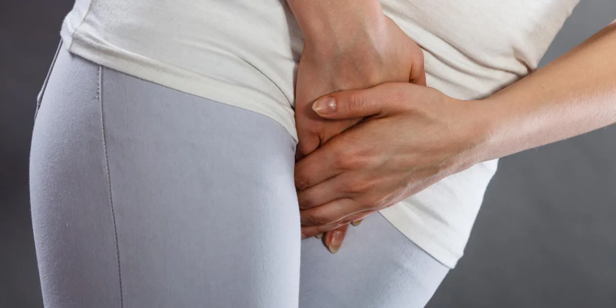 closeup young sick woman with hands holding pressing her crotch lower abdomen medical or gynecological problems, healthcare concept closeup young sick woman with hands holding pressing her crotch lower abdomen medical or gynecological problems, healthcare concept