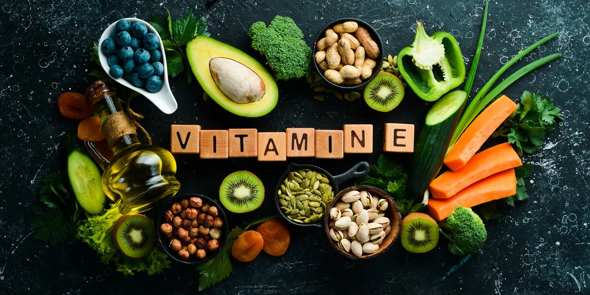 foods rich in vitamin e pumpkin, broccoli, dried apricots, parsley, avocado and vegetables the inscription vitamin e top view foods rich in vitamin e pumpkin, broccoli, dried apricots, parsley, avocado and vegetables the inscription vitamin e top view