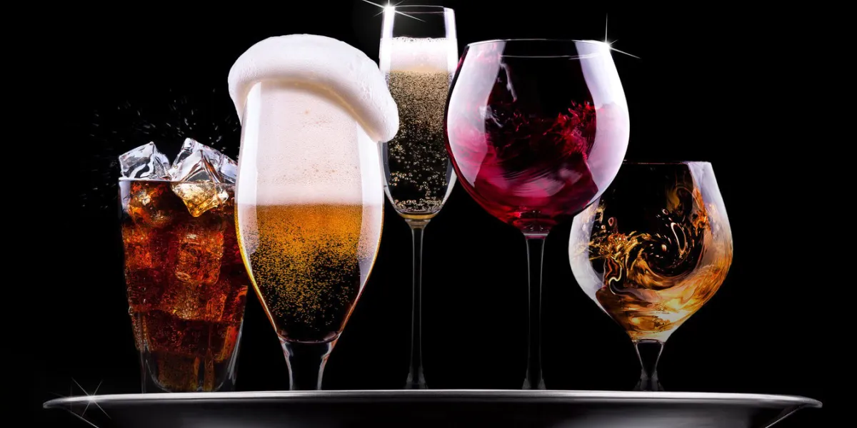 tray with different drinks on black background - champagne, beer, cocktail, wine, brandy, whiskey, scotch, vodka, cognac