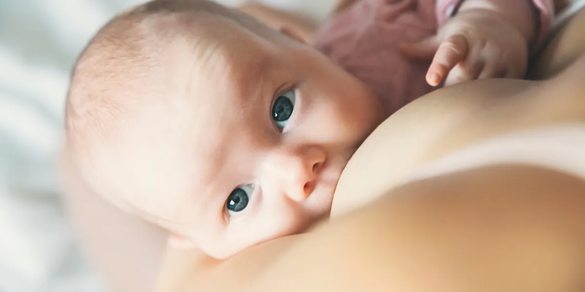 baby eating mother's milk mother breastfeeding baby beautiful mom breast feeding her newborn child young woman nursing and feeding baby concept of lactation infant