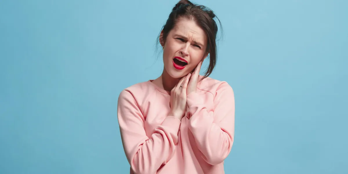 sore ear ear ache concept the sad crying woman with headache or pain on trendy blue studio background facial expressions and people emotions concept front view half-length portrait young woman sore ear ear ache concept the sad crying woman with headache or pain on trendy blue studio background facial expressions and people emotions concept front view half-length portrait young woman