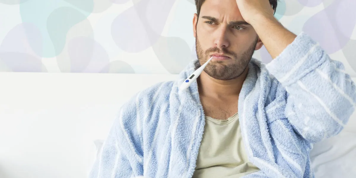 homme malade avec thermomètre dans la bouche, assis sur le lit à la maison homme malade avec thermomètre dans la bouche, assis sur le lit à la maison