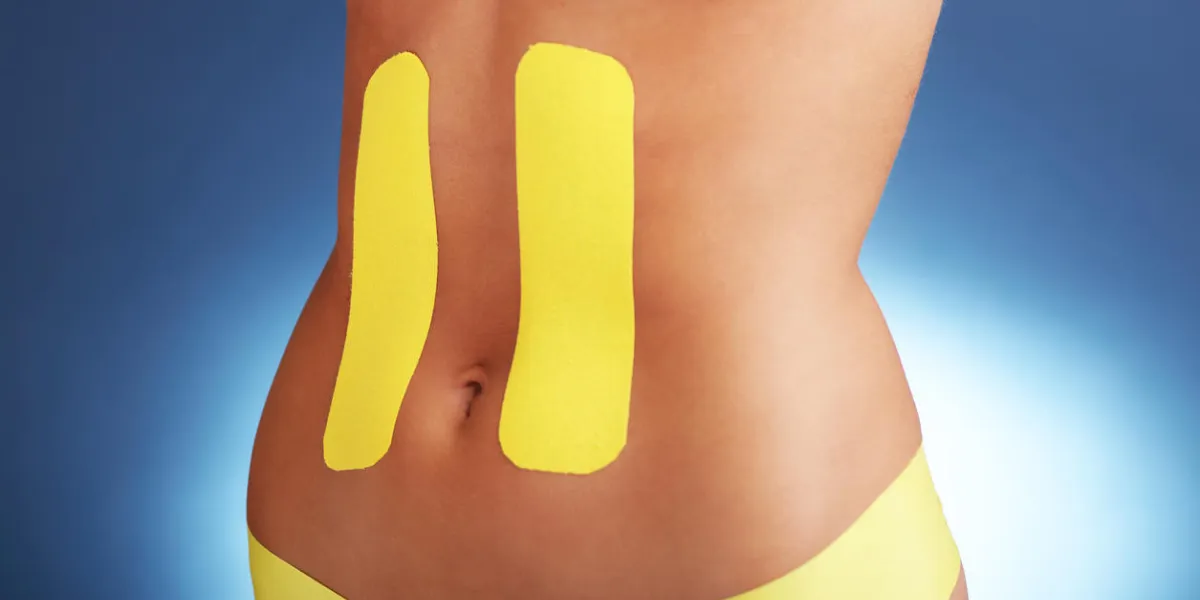 picture showing special physio tape put on injured abdomen over white background