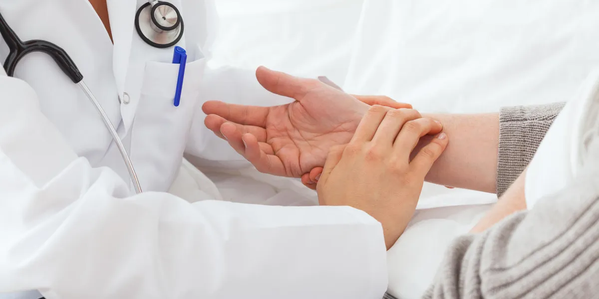 the doctor is measuring the patient pulse on home visit the doctor is measuring the patient pulse on home visit