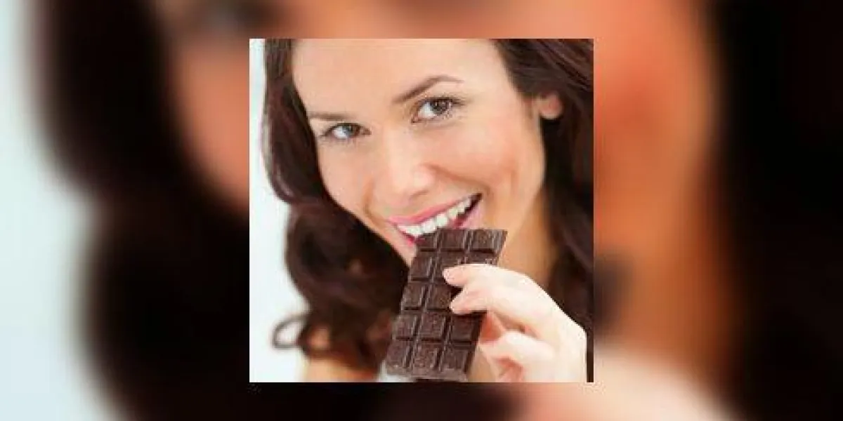 closeup portrait belle jeune femme mangeant une barre de chocolat