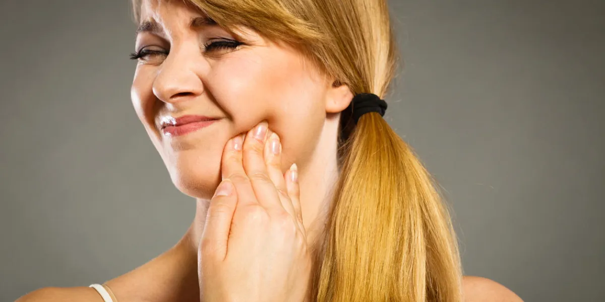 dental care and toothache young woman achy girl suffering from terrible tooth pain, touching pressing her cheek by hand palm dental care and toothache young woman achy girl suffering from terrible tooth pain, touching pressing her cheek by hand palm