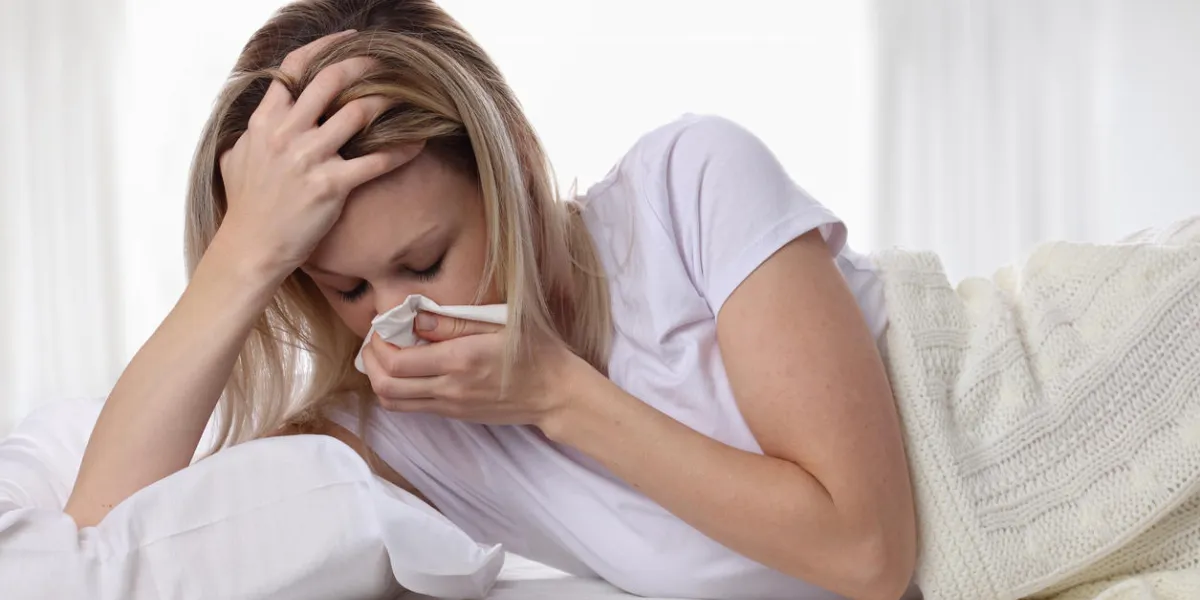 woman sneezing and holding tissue ,flu symptoms healthcare and medical concept woman sneezing and holding tissue ,flu symptoms healthcare and medical concept