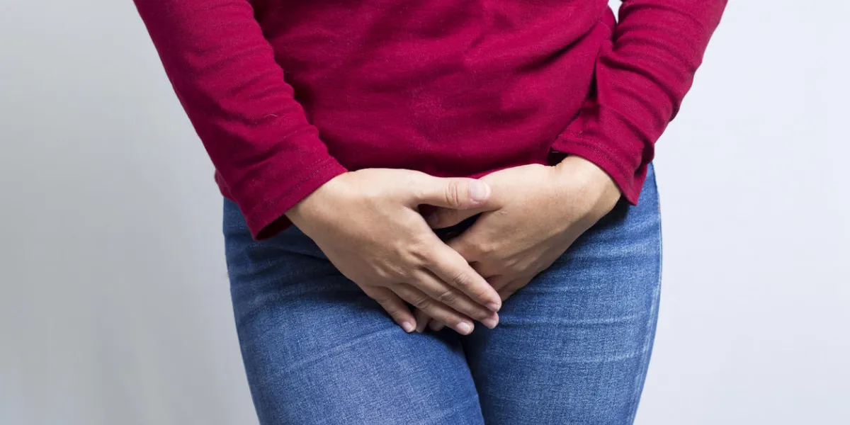 woman with hands holding her crotch isolated in a white background woman with hands holding her crotch isolated in a white background