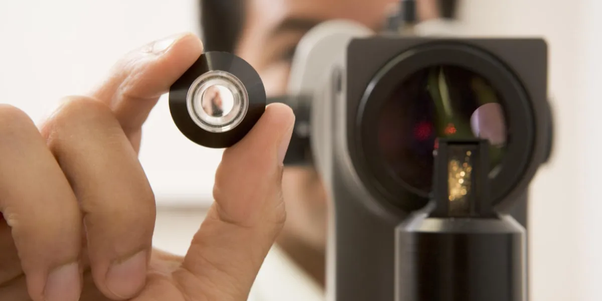 doctor looking through eye exam machine to camera