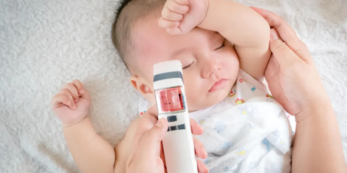 blurred of image baby sick with thermometer