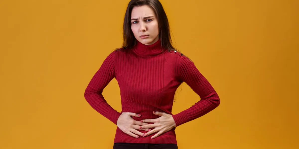 an attractive young woman grabbed her stomach from pain of lower abdomen, menstrual cycle does not give rest to doing work and brings suffering in discomfort, refusal from sports and entertainment an attractive young woman grabbed her stomach from pain of lower abdomen, menstrual cycle does not give rest to doing work and brings suffering in discomfort, refusal from sports and entertainment