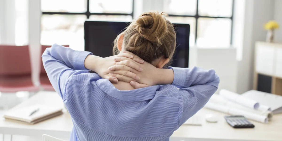 tired businesswoman holding her nape tired businesswoman holding her nape