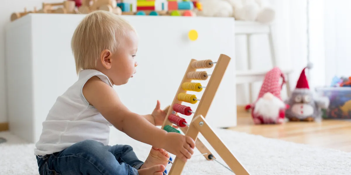 cute little baby boy, playing with abacus at home, sunny kids room cute little baby boy, playing with abacus at home, sunny kids room